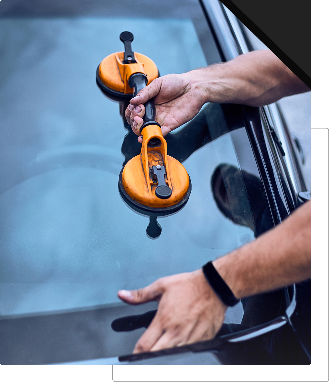 Hands using suction tool on glass
