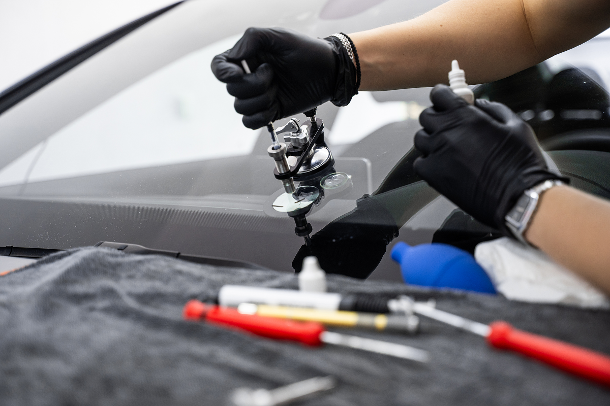 Technician fixing a car windshield